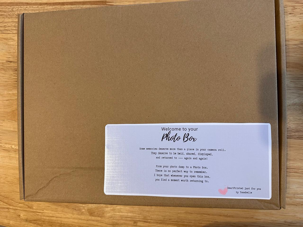 Closed HEARTPRINTS Curated Photo Box with a personalized welcome label