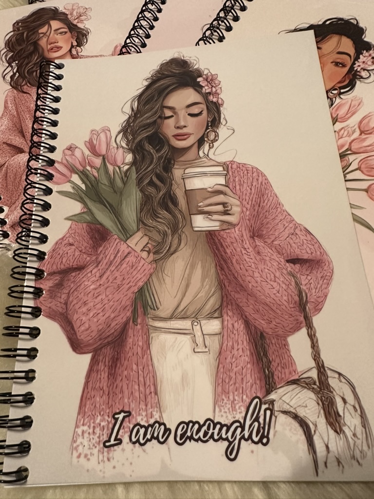 Collection of finished HEARTPRINTS personalized metal-wired notebooks with coordinated pink illustrated covers