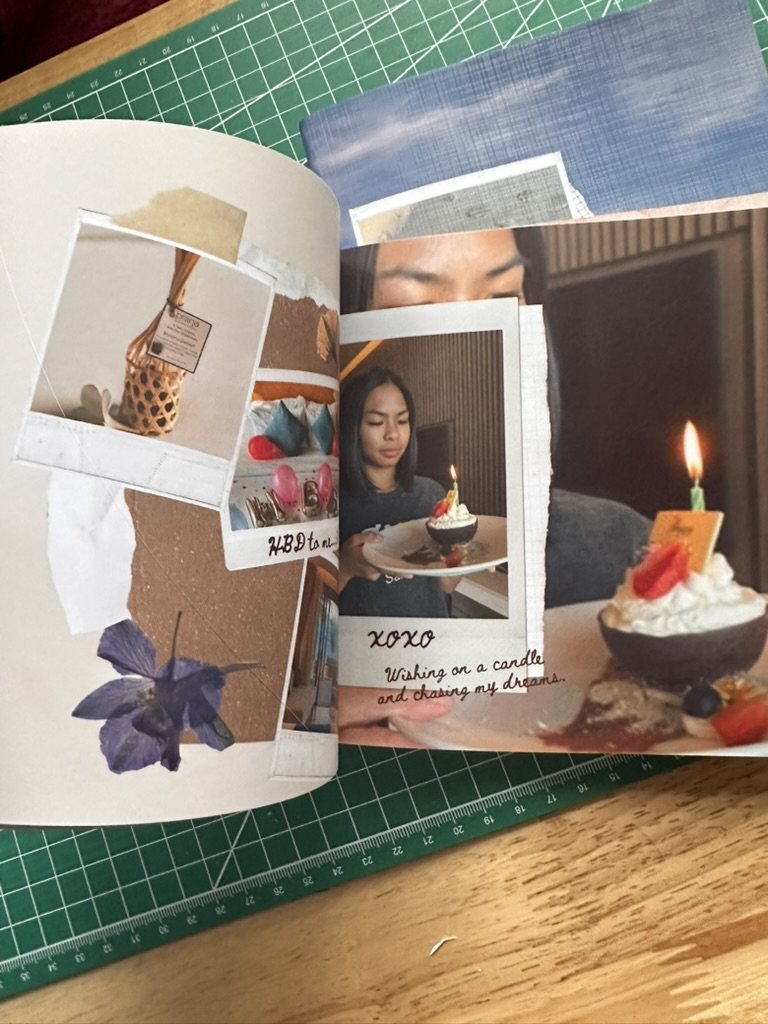 Open HEARTPRINTS photobook with a scrapbook-inspired birthday layout and layered photographs